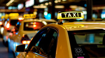taxi uber lyft park on the roadside