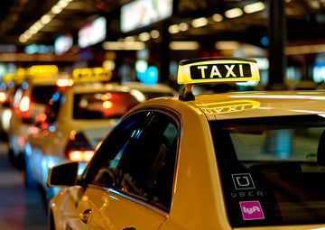 taxi uber lyft park on the roadside